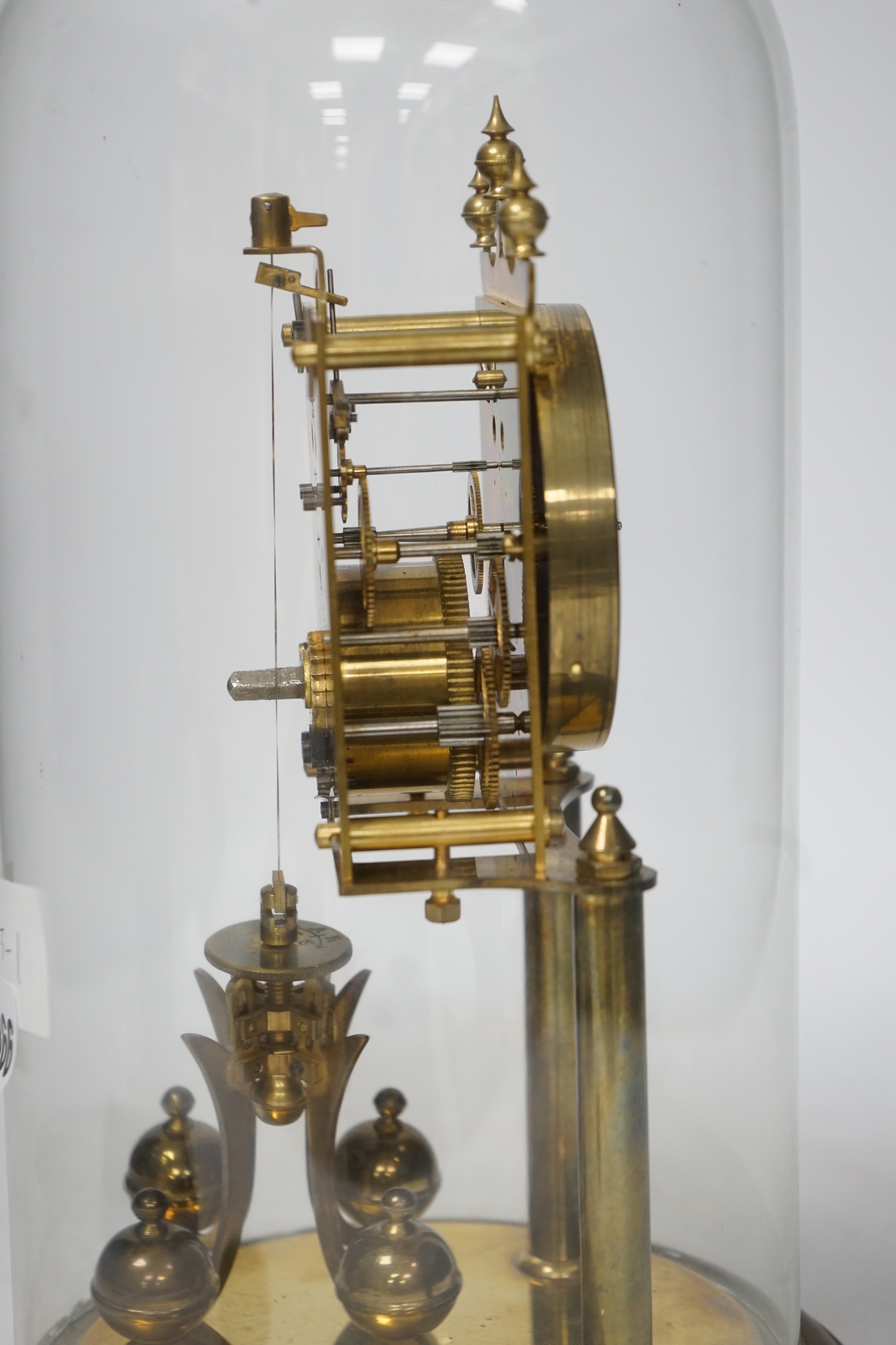 A 20th century German brass torsion pendulum clock under brass dome, 32cm high